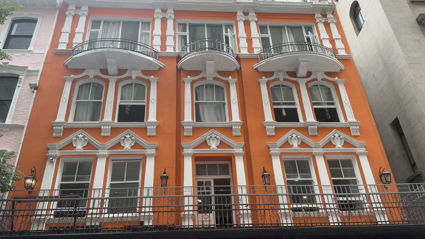 An old orange painted Victorian era building in the city centre of Cape Town.