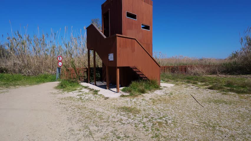 Raised birdwatching hut overlooking a natural wetland