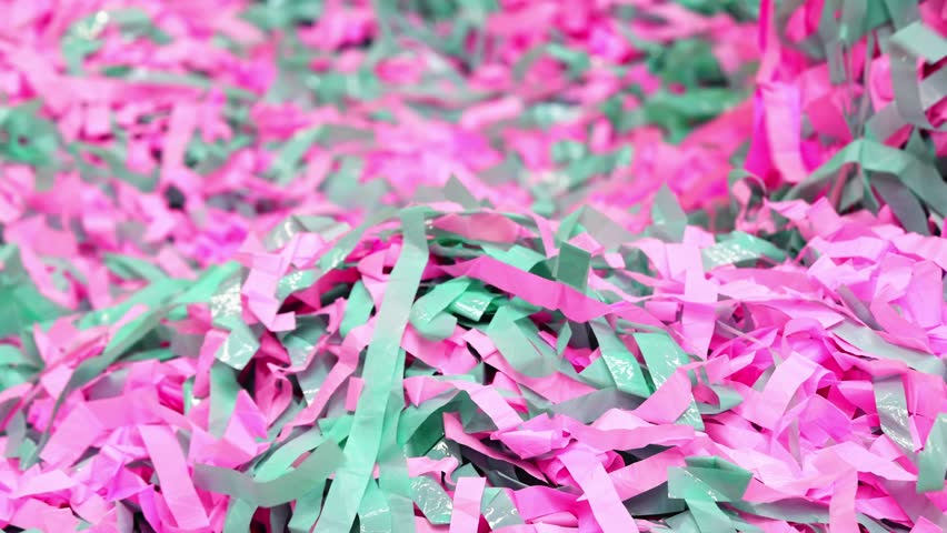 many colored confetti on floor in playground for kids.pink and teal tissue paper party decoration.entertainer prepares for children to throw the colored strips into air.birthday party, play zone - Powered by Shutterstock - Get 15% off with code: PIKWIZARD15
