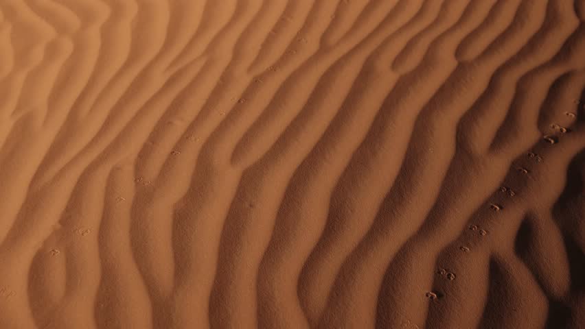 aerial view of sand dune in the Sahara desert with warm golden hours light at sunset, scenic patterns in North African landscape Mother Nature calm relaxing drone footage