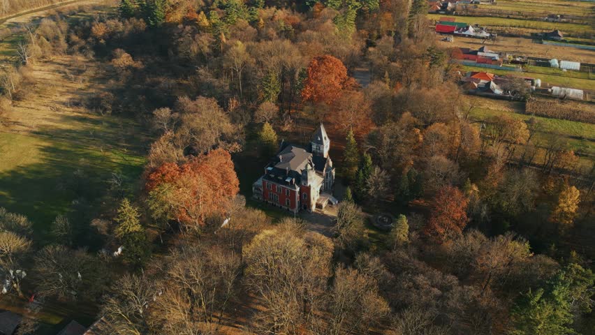 Autumn Trees Surrounding Ghica Castle In Dofteana, Romania. aerial orbiting shot