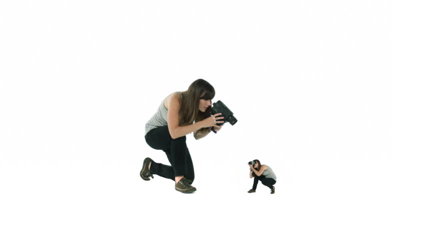 Woman films a smaller version of herself, who in turn films her larger twin.