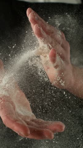 Super Slow Motion Chef Clapping Hands with Flour . Filmed on High Speed Cinema Camera, 1000 fps . Closeup of Bread or Pizza Dough Preparation
