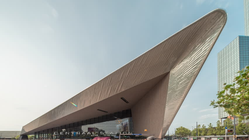 Hyperlapse of Rotterdam Central Station, the main railway hub in South Holland, Netherlands. Modern architecture with skyscrapers in the background and busy people on the square timelapse