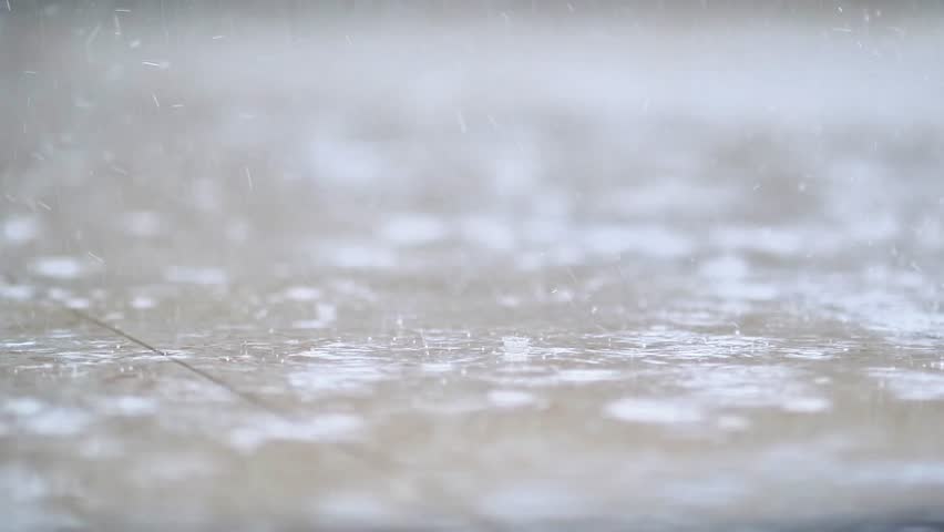 Heavy rain, raindrops dripping onto the terrace floor, macro photography
