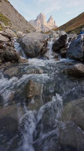 French Alps landscape of Aiguilles d Arves of striking trio with rugged rocky mountain peak and cascade flowing during autumn in Maurienne Valley at Savoie, France