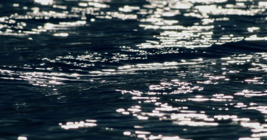 Aerial view slow-motion water wave reflection 
