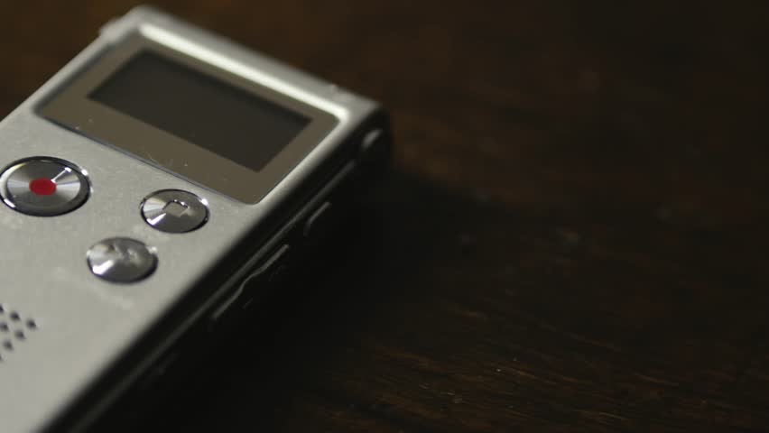 Digital dictaphone audio device recording button activated CLOSE-UP SLIDE shot