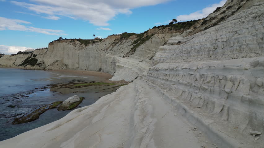 Close drone flight of famous white cliffs of Scala dei Turchi, natural landscapes along beautiful coastline of Southern Sicily Italy
