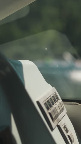 Dashboard with keys and levers in skipper pilothouse closeup. Motor boat control cabin interior and blurry water scooter in sea bay. Watercraft voyage