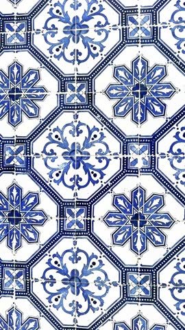 Traditional white and blue glazed tile azulejos on the facade of the house in Lisbon, Portugal. Abstract background, Vertical video
