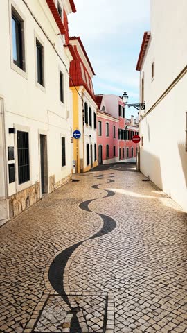 Colorful architecture in Cascais, Portugal. Walking on the cozy street at sunny morning. Famous travel destination. Vertical video
