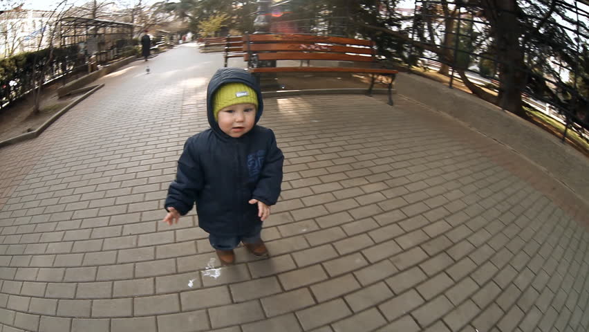 Child play in park, running after camera