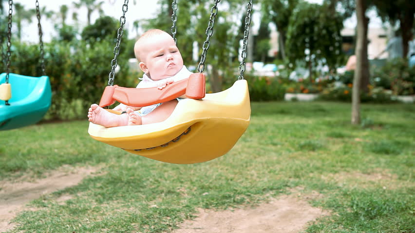 Baby in  swing outdoors