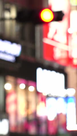 SHIBUYA, TOKYO, JAPAN : View of crowd of people walking around Shibuya station at night. Crowded downtown area in Tokyo. Japanese people, urban city nightlife and traffic concept vertical video.