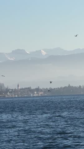 View of Lake Zurich with the snow-capped Swiss Alps in the background