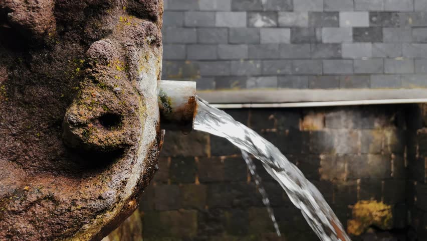 Water flows from the spring directly through old pipes and ancient relief stones