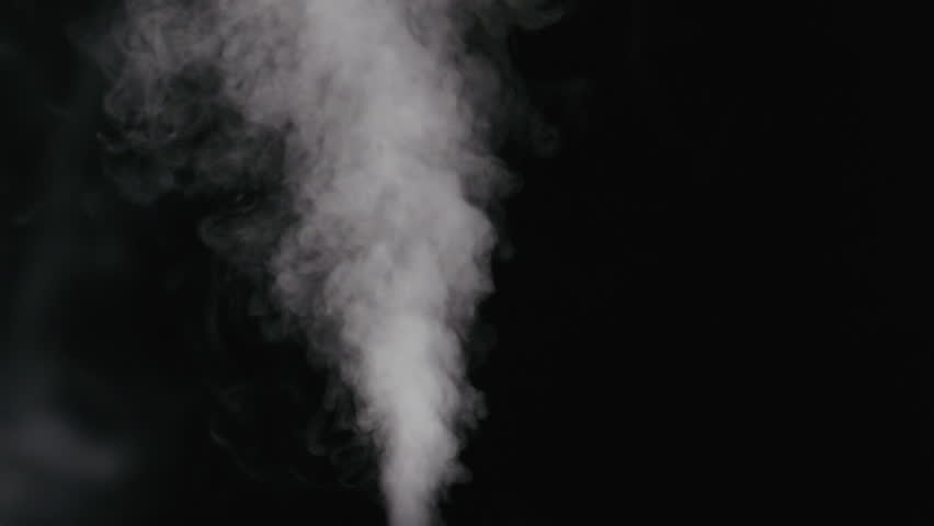 Slow motion water mist stream with wind effect over black background