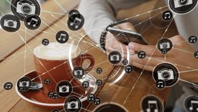 Using smartphone with animation digital icons, person having coffee on table. Technology, innovation, communication, casual, lifestyle, relaxation - Powered by Shutterstock - Get 15% off with code: PIKWIZARD15