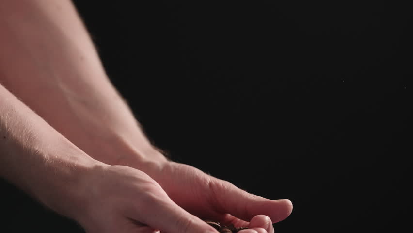 Slow motion mam pour coffee beans over balck background