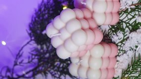 vertical video. Cute white and pink Bubble candles on purple background. items for New Year's interior decor. - Powered by Shutterstock - Get 15% off with code: PIKWIZARD15