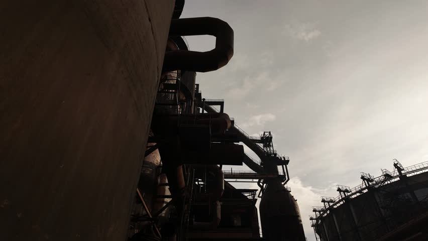 Steel foundry Industrial architecture silhouetted against skyTIMELAPSE