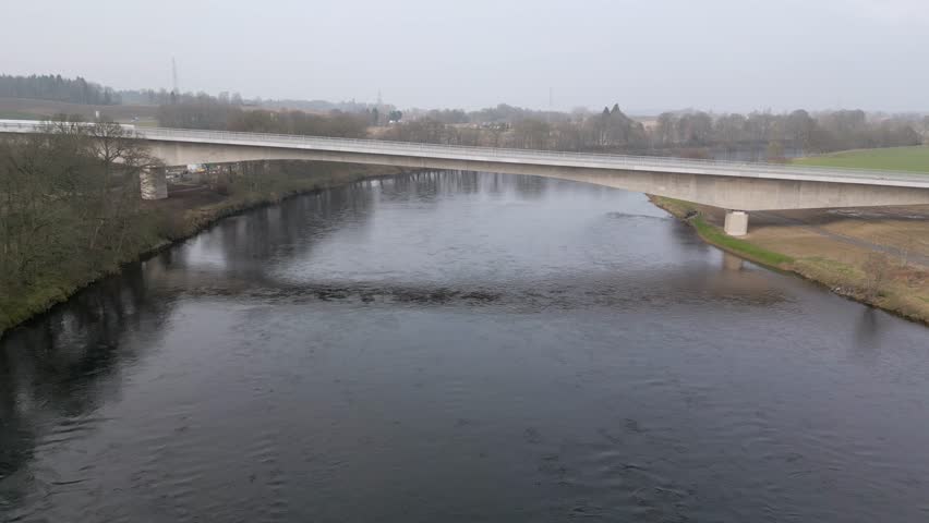 Aerial view of the newly build bridge across River Tay. Drone descending camera tilting up