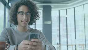 Using smartphone with financial graphs and data overlay animation, person smiling. Technology, finance, analytics, digital, innovation, growth - Powered by Shutterstock - Get 15% off with code: PIKWIZARD15