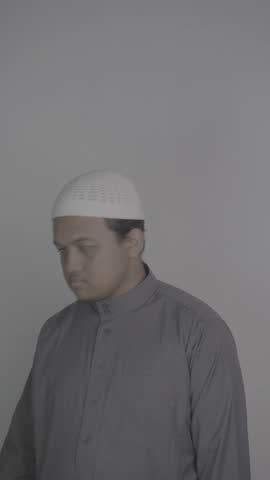 Southeast Asian Muslim man in a grey robe holds a lot of money which he then counts and gives to those around him. and video in S-Log3, S-Gamut3.Cine