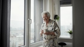 Video of beautiful old woman smiling, expecting a visitor. Banner with copy space. - Powered by Shutterstock - Get 15% off with code: PIKWIZARD15