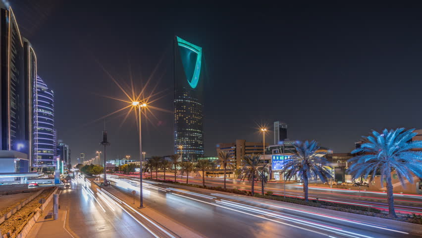 Panoramic aerial night timelapse of Riyadh featuring highway traffic, Kingdom Tower the tallest skyscraper and landmark of Saudi Arabia's capital. Illuminated modern buildings surround vibrant scene