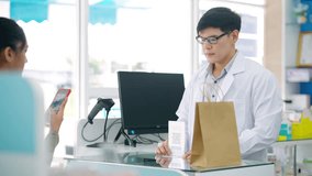Medical pharmacy clinic, pharmaceutical, pharmacist and contactless payment technology. Asian woman customer buy medicine with using smartphone scan QR code making online banking payment at drugstore. - Powered by Shutterstock - Get 15% off with code: PIKWIZARD15