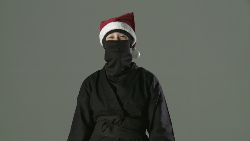 Masked ninja assassin does awesome finger exercises while wearing a Santa hat