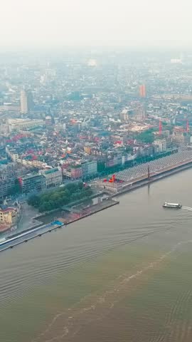 Vertical video. Antwerp, Belgium. River public transport on the river Scheldt (Escaut). Embankment of Antwerp. Summer morning, Aerial View. Rich colors