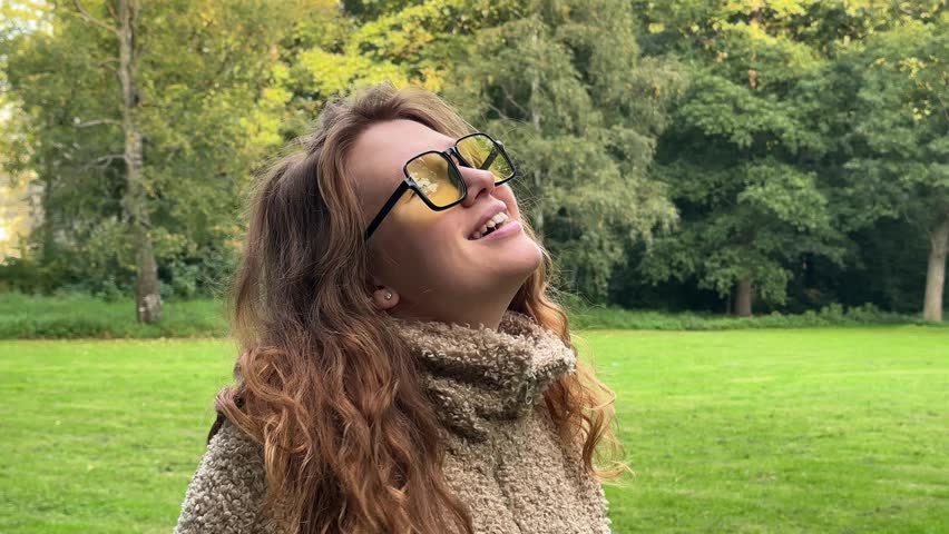 young woman enjoying good weather wearing yellow glasses