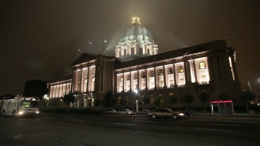 San Francisco, California - January, 2009 - Wide angle shot of San Francisco City Hall with a Muni bus passing by on a misty and foggy night.