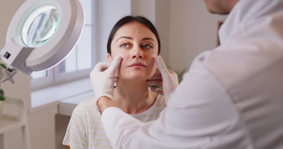 Plastic surgeon, doctor or nurse provides a consultation for a patient before a beauty procedure in a hospital. Medical advice, cosmetology, and surgery preparation in a clinical environment.