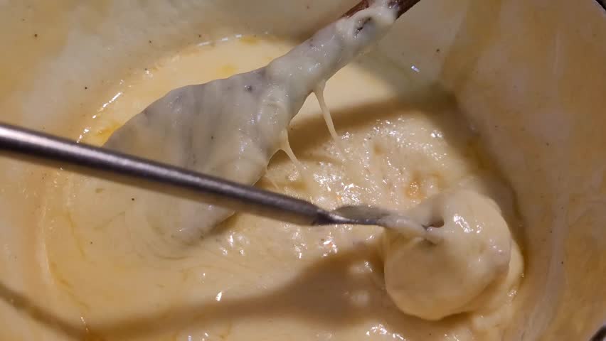 Piece of bread attached to a fork and which catches the cheese from a fondue savoyarde (or cheese fondue)