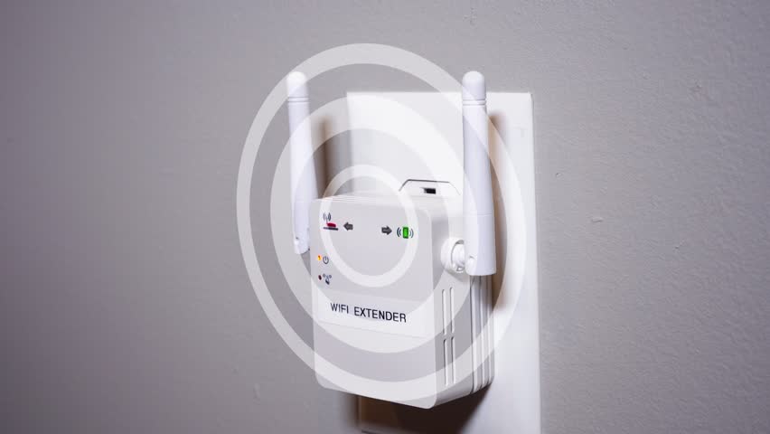 A close up shot of a man plugging in a typical WiFi extender into a household wall outlet. With simulated hotspot radio waves emanating from the device.  	