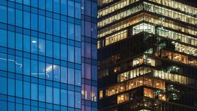 Day to night transition office windows lights time-lapse, modern high-rise skyscrapers, financial district tall glass buildings in downtown looking up wide angle shot, people working late evening - Powered by Shutterstock - Get 15% off with code: PIKWIZARD15