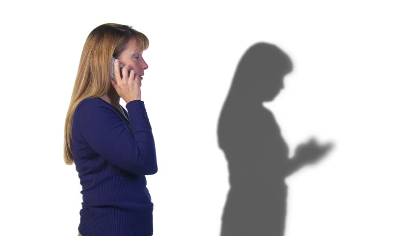 Woman's shadow gets more and more frustrated on a call while the caller herself