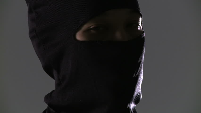 Camera pans and tilts to reveal a close up of a masked ninja assassin, who then