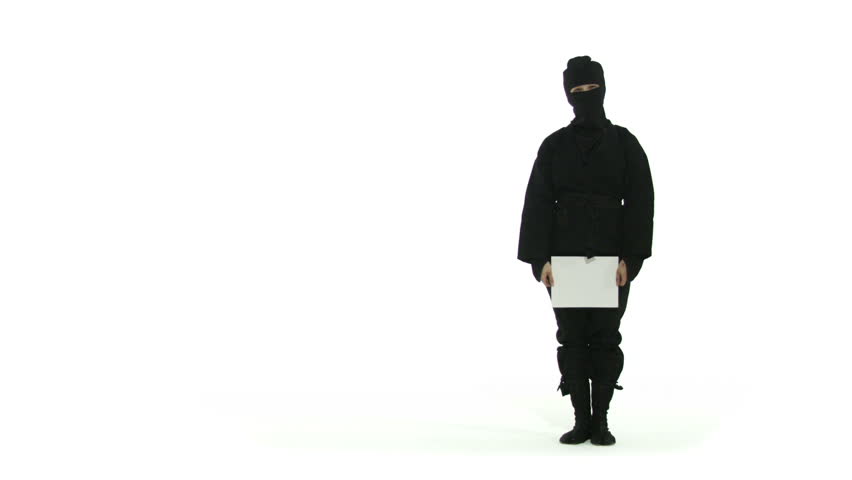 Masked ninja holds up a SALE sign. Close up shot against a white background.