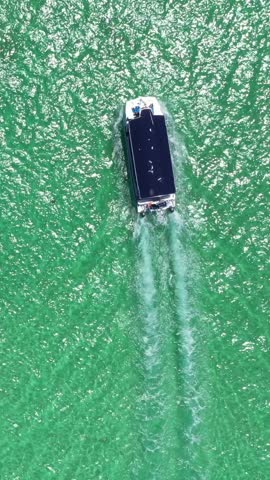 Aerial view from drone on caribbean sea with boat floating in water, tropical destination. Dominican Republic. Vertical footage