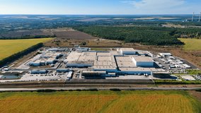 Approaching the warehouses of a large industrial plant. Huge modern enterprise in the countryside. - Powered by Shutterstock - Get 15% off with code: PIKWIZARD15