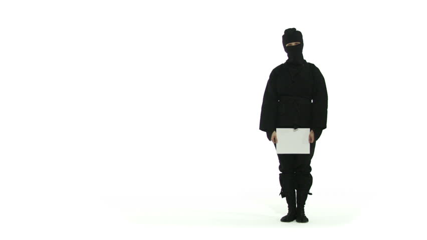 Masked ninja holds up a SALE sign. Full length shot against a white background.