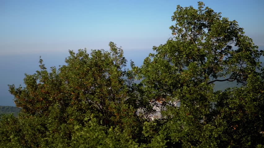 Picturesque view of Budva city nestled between mountains and the Adriatic Sea, offering a serene coastal panorama.