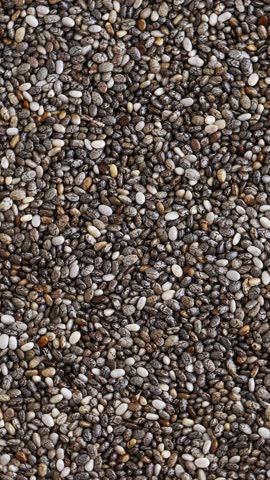 Chia seeds background, rotating. Vertical footage