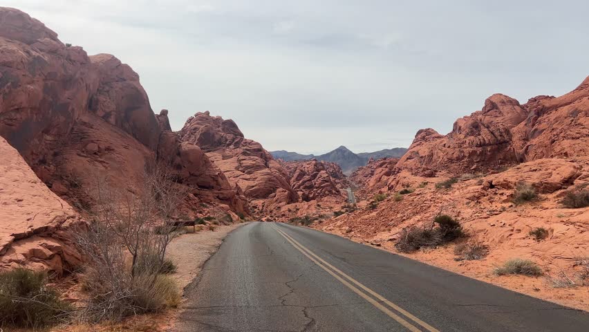 Beautiful view of a winding road among breathtaking red rock formations and the vast desert of Arizona, USA
