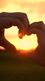 Happy couple man woman making heart gesture with fingers in sun park. Heart with fingers symbol Valentine's Day. Married couple man woman joined fingers in heart shape outdoors at sunset. People love - Powered by Shutterstock - Get 15% off with code: PIKWIZARD15